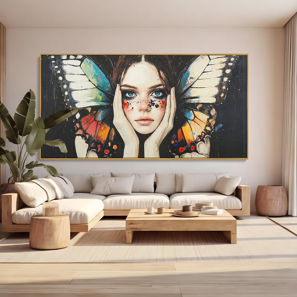Tablou canvas cu tablou canvas cu femeie si aripi de fluture, in rama de aluminiu auriu, pe perete intr-un living